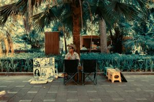 free-photo-of-an-artist-sitting-on-a-sidewalk